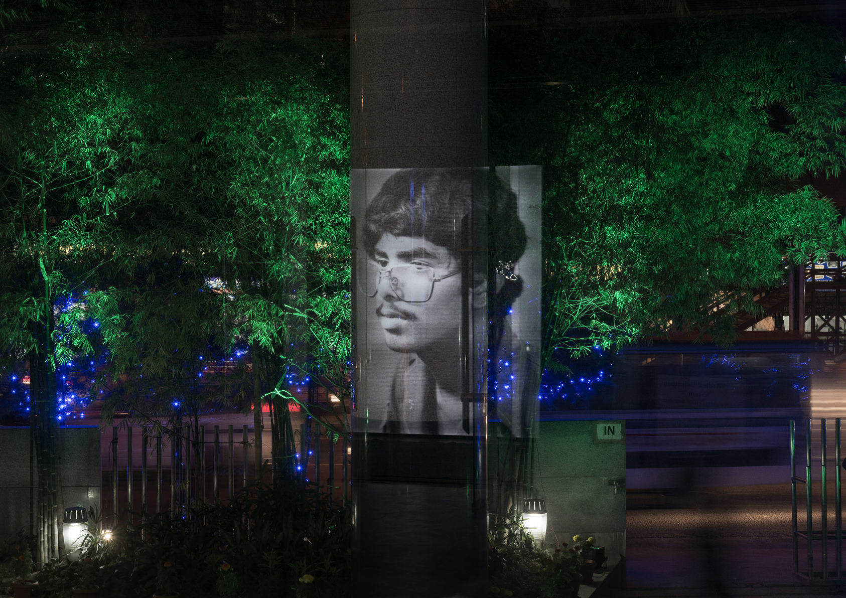 Illuminated portrait reflected in the Bengal Foundation garden