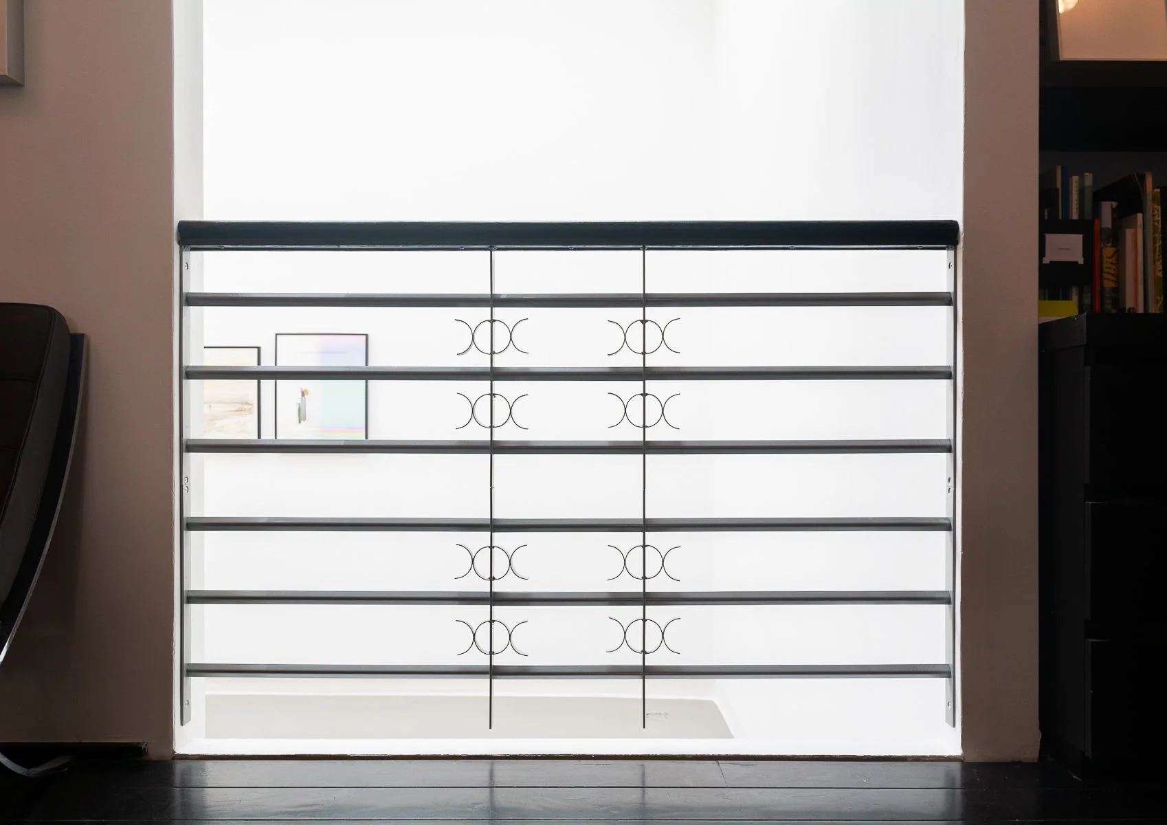 Galvanised steel security grill installed across an office window