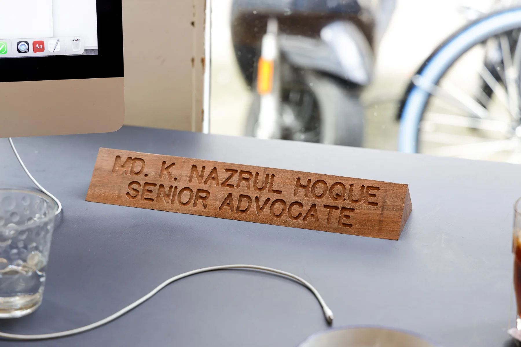 CNC-machined oak desk nameplate reading MD. K. Nazrul Hoque Senior Advocate