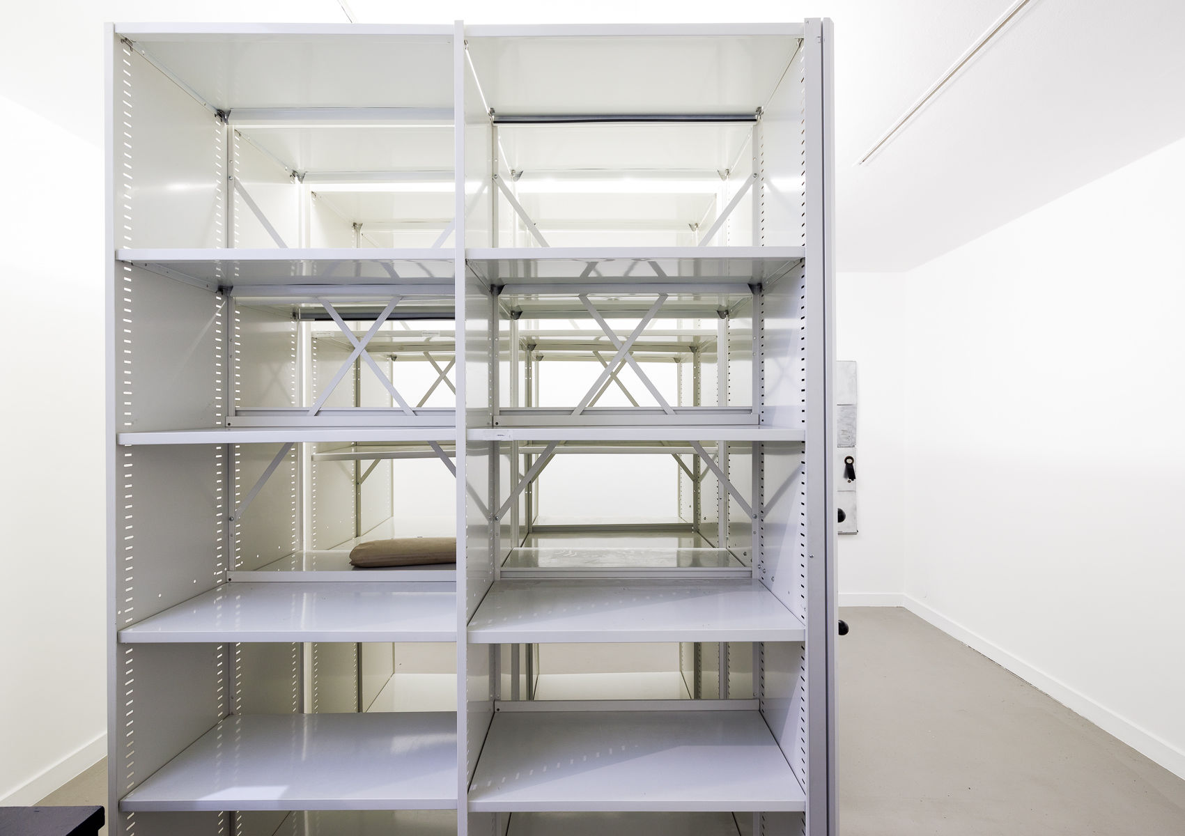 Mobile archive shelving filled with aged papers