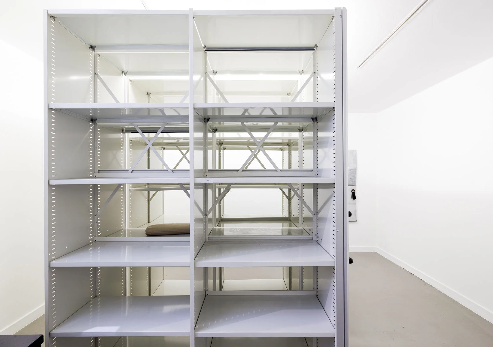 Mobile archive shelving filled with aged papers