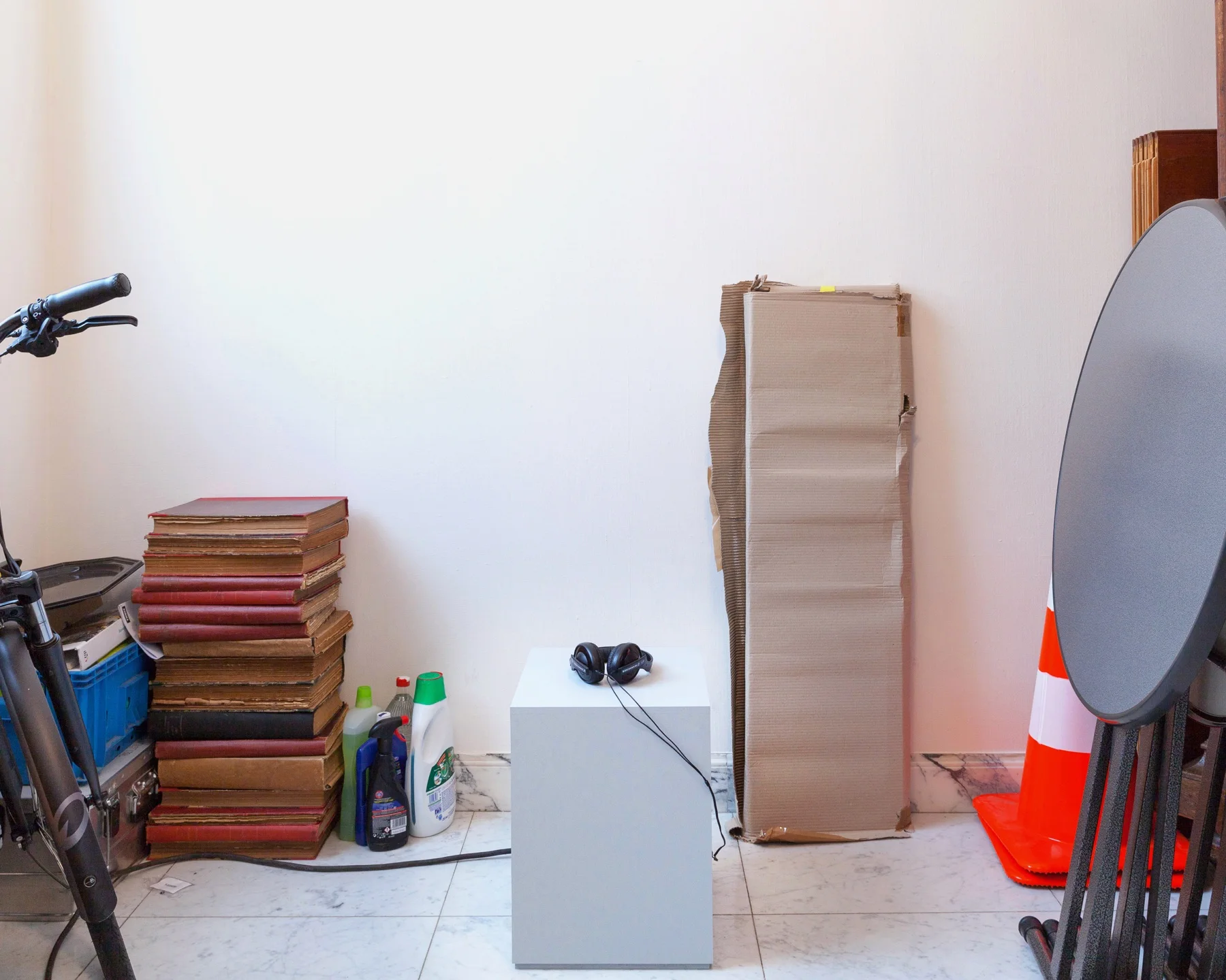 Headphones and media player placed out of reach on a custom plinth