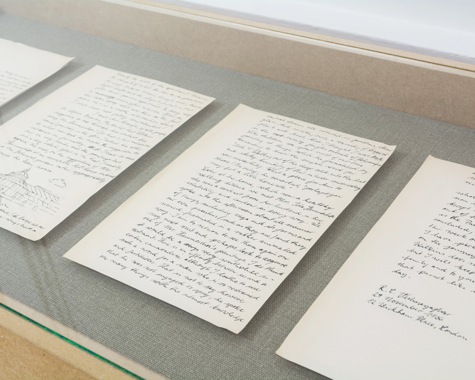 Handwritten letter and artist’s notebook displayed in a vitrine