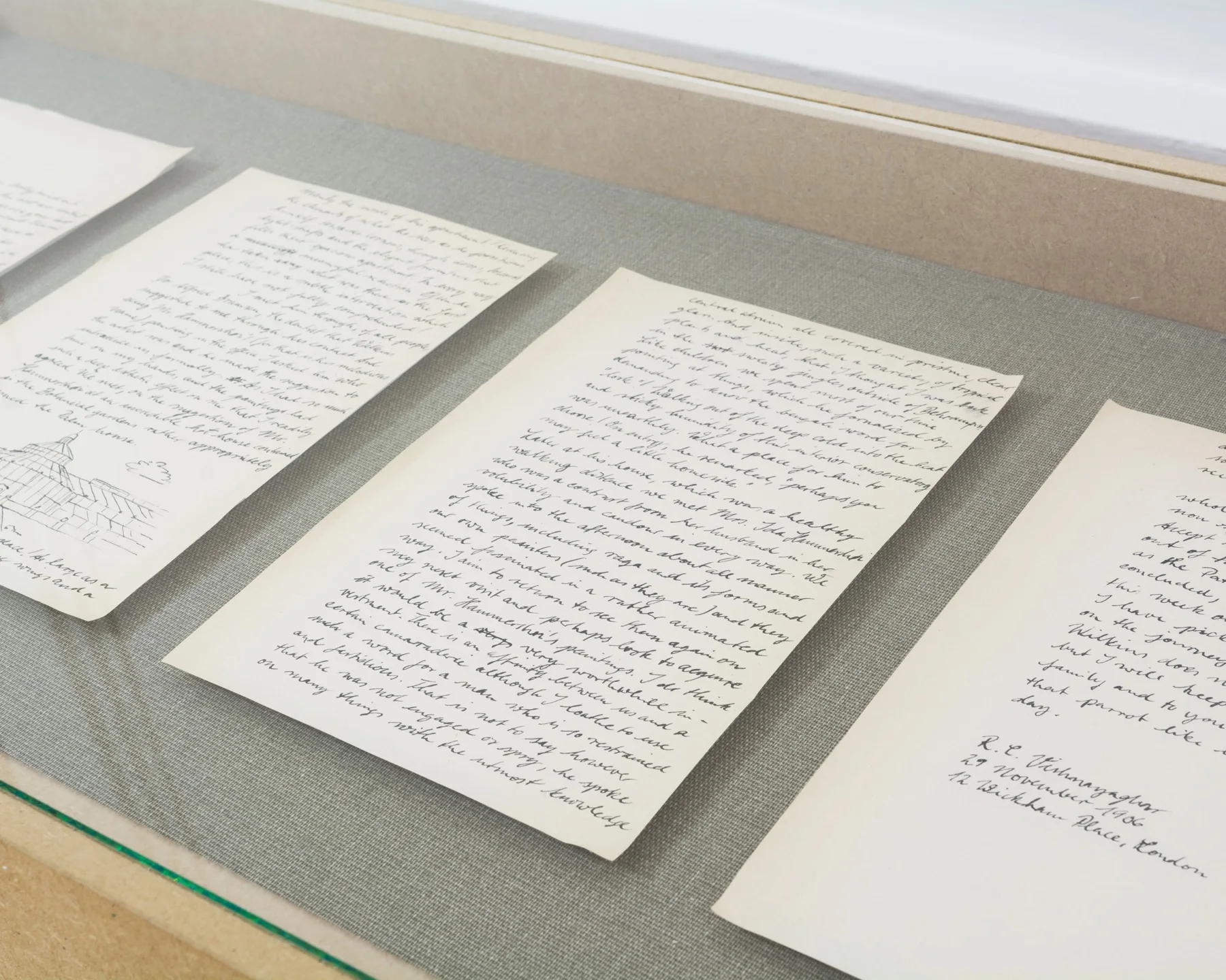 Handwritten letter and artist’s notebook displayed in a vitrine