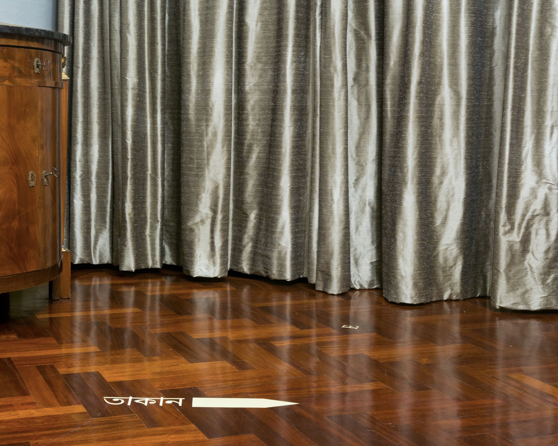 Silvery interior of the Governor’s Mansion with Bengali directional text