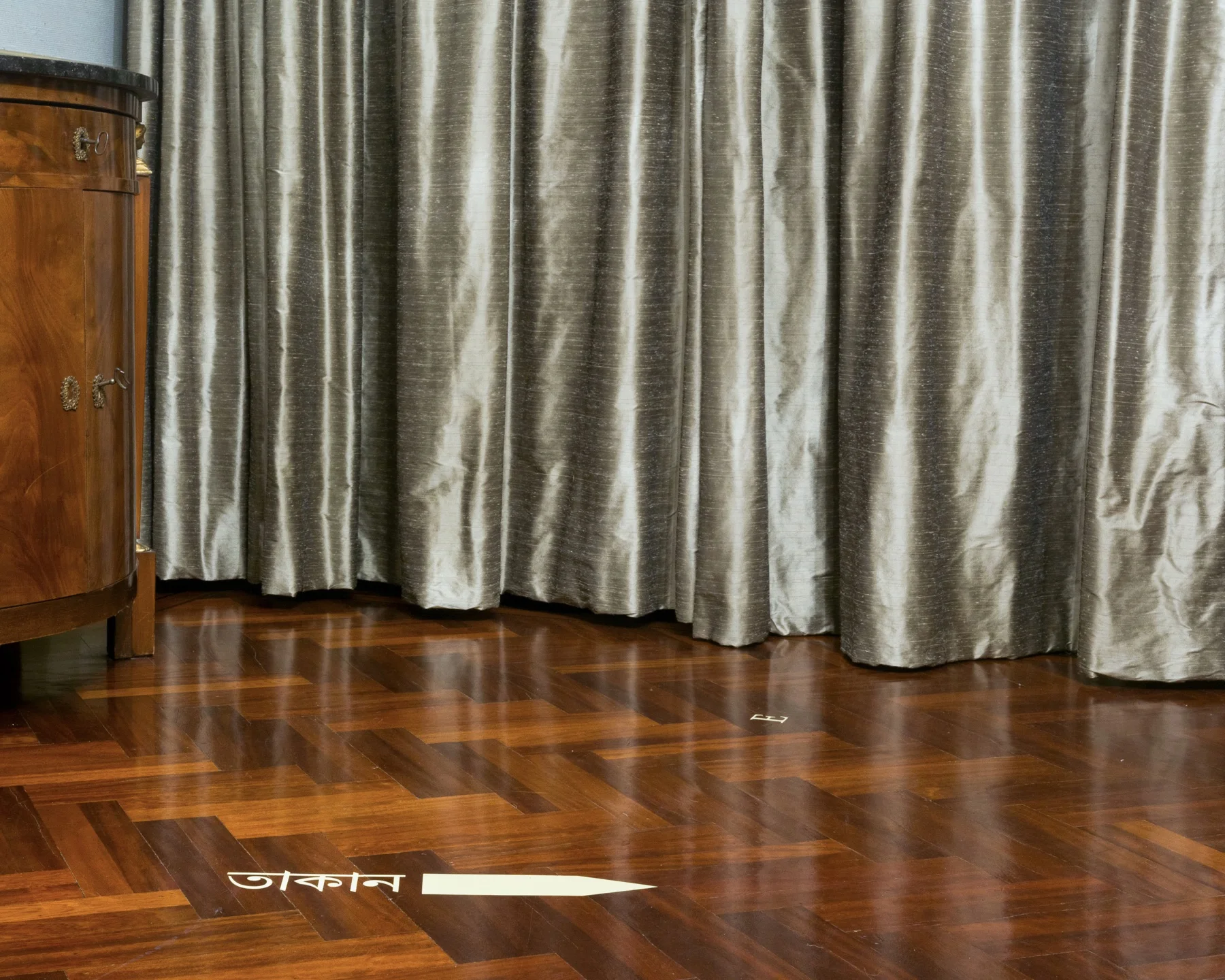 Silvery interior of the Governor’s Mansion with Bengali directional text