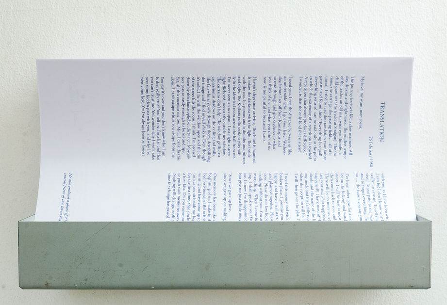 Printed translation held in a metal wall rack