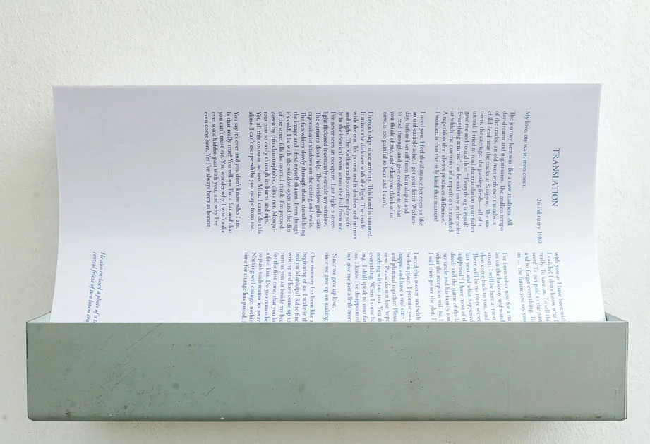 Printed translation held in a metal wall rack