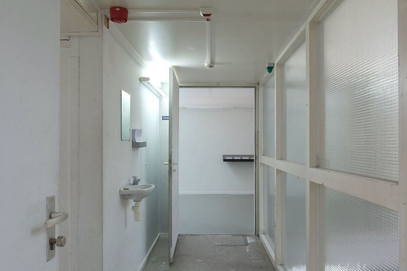 Washbasin, soap, mirror and indicator lights in a corridor