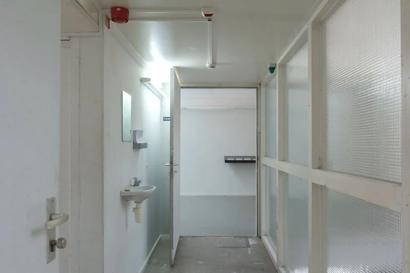 Washbasin, soap, mirror and indicator lights in a corridor