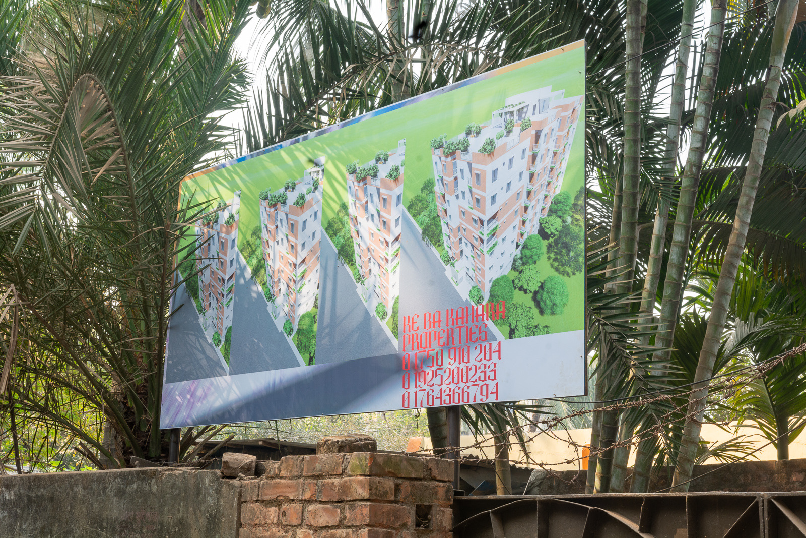 Real-estate billboard beside the shrouded Faydabad house