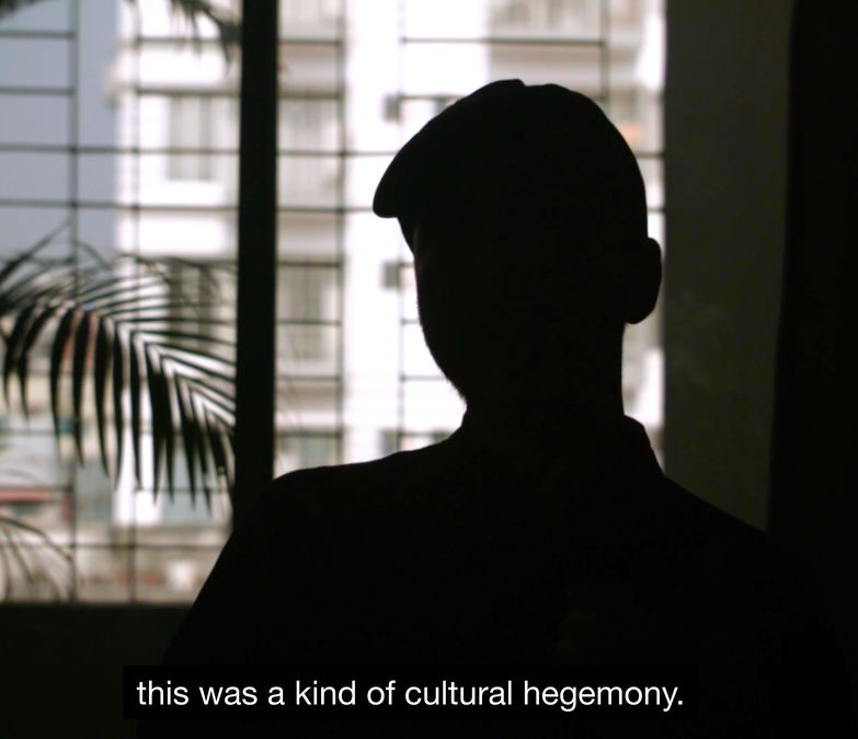 Film still from Janus Tussle showing an obscured interview