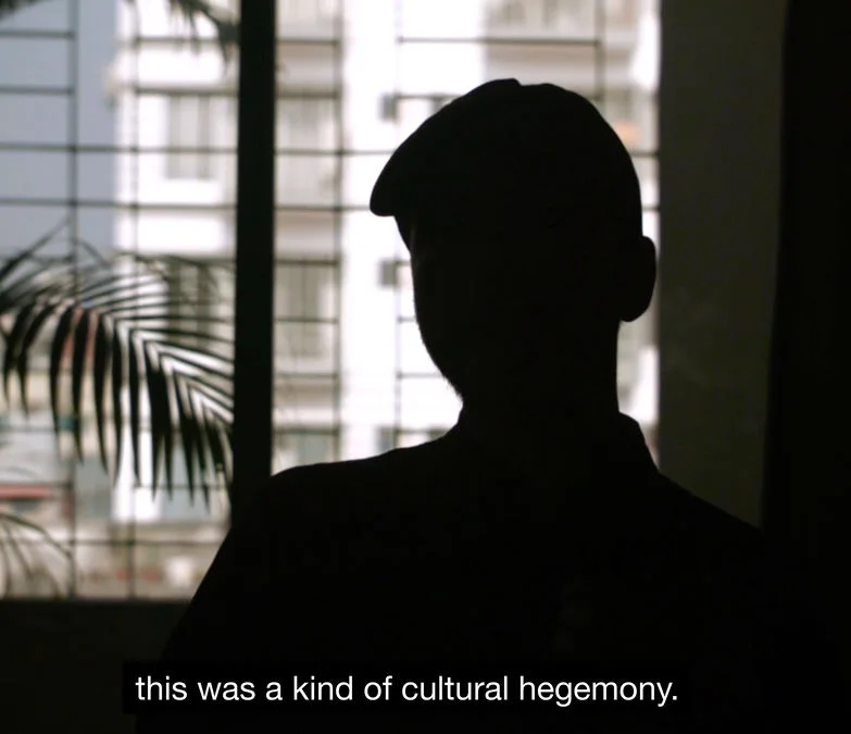 Film still from Janus Tussle showing an obscured interview