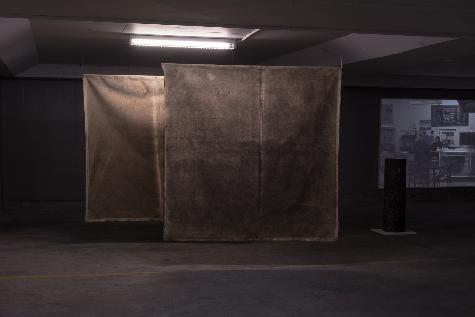 Smoke-darkened cotton panels installed in Means